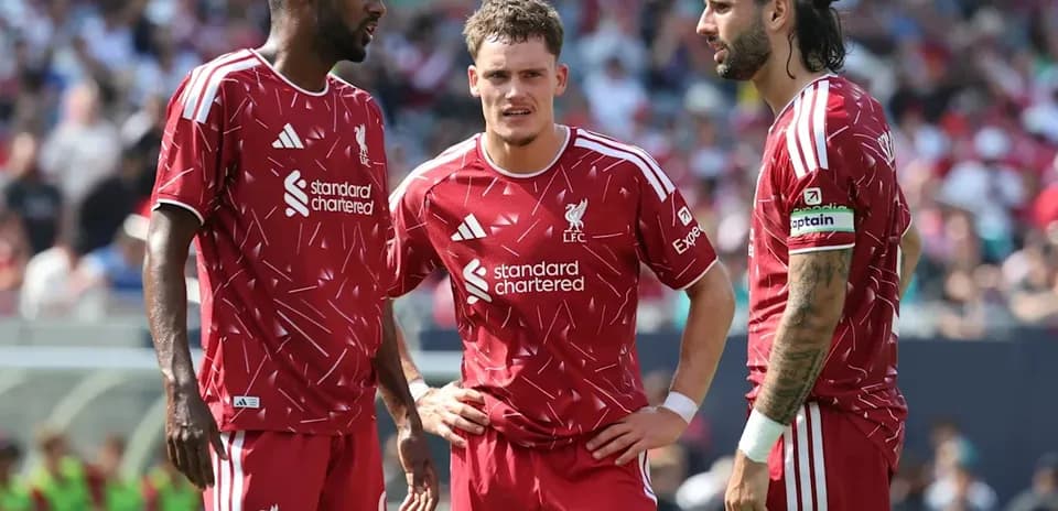 Three Liverpool players discussing during match