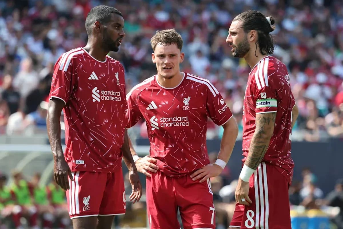 Three Liverpool players discussing during match