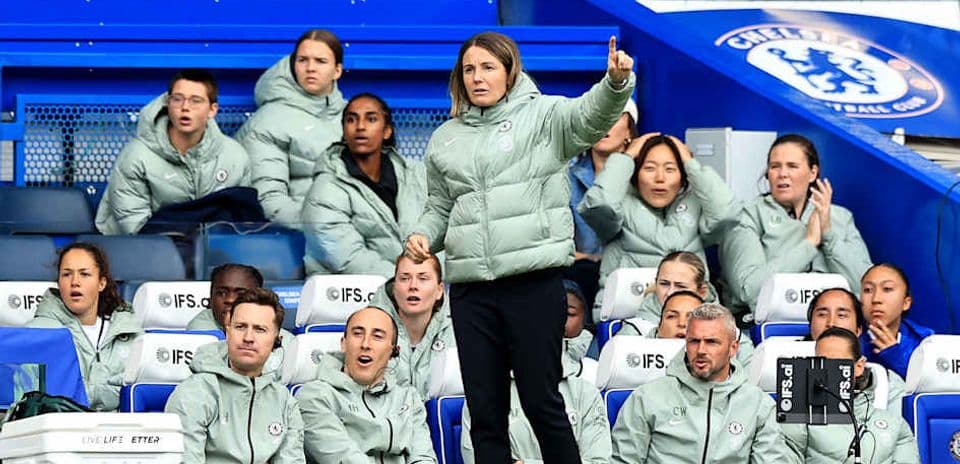 Coach giving instructions to players on bench