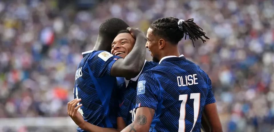 Three players celebrating a goal on the pitch