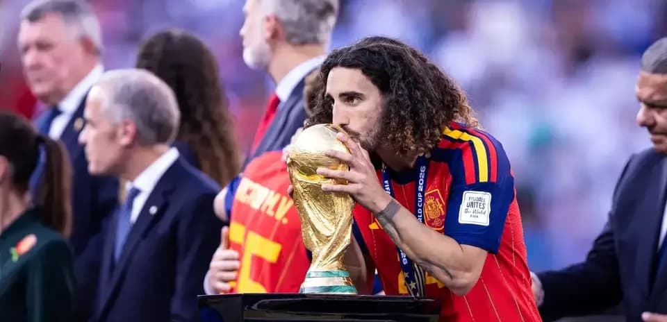 Player kissing the FIFA World Cup trophy on podium