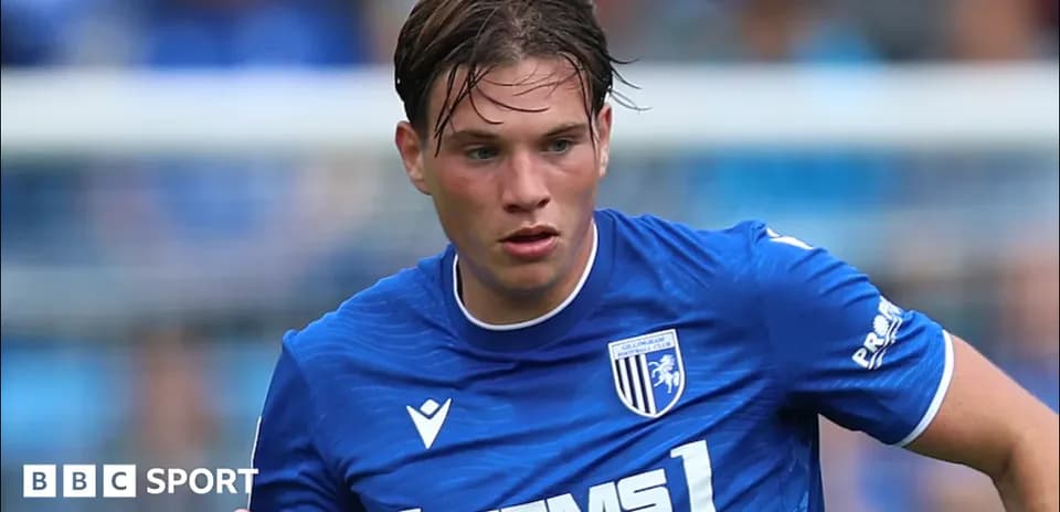Gillingham FC player running with ball during match