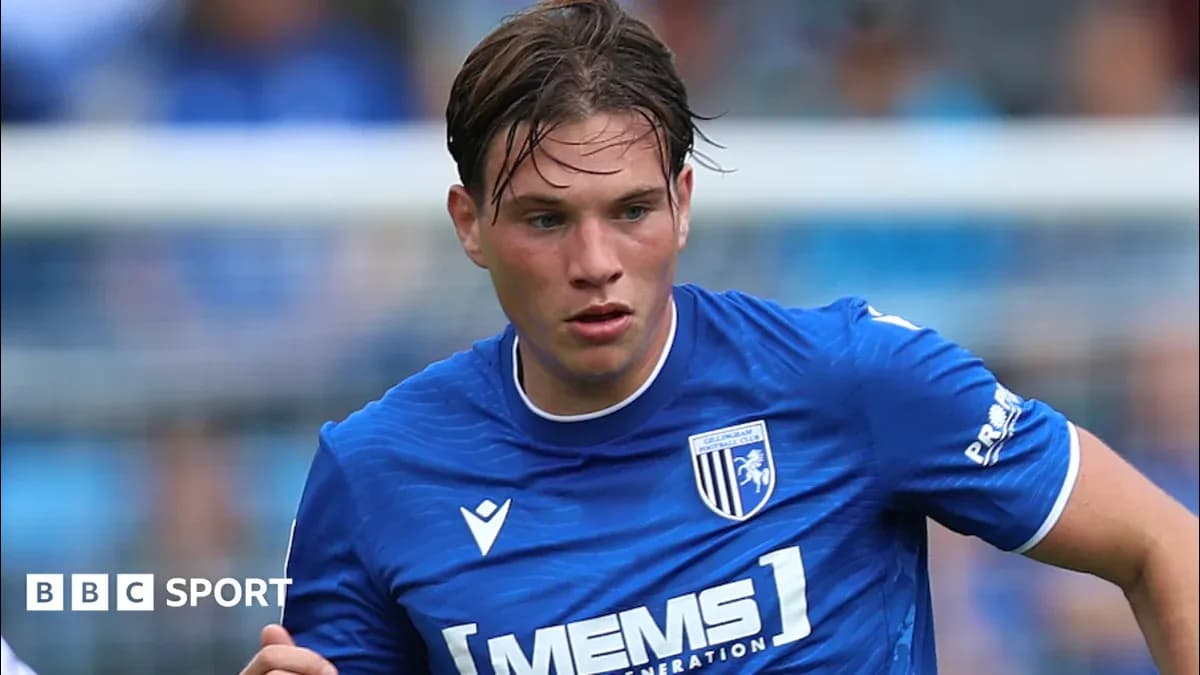 Gillingham FC player running with ball during match