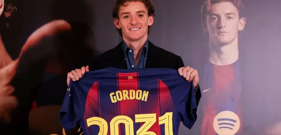 Player holding FC Barcelona jersey at presentation