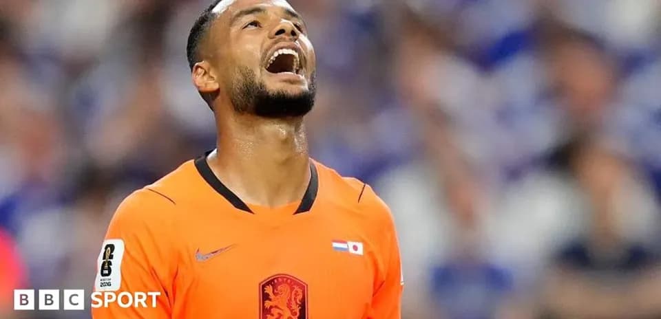 Player in orange jersey looking upwards during match
