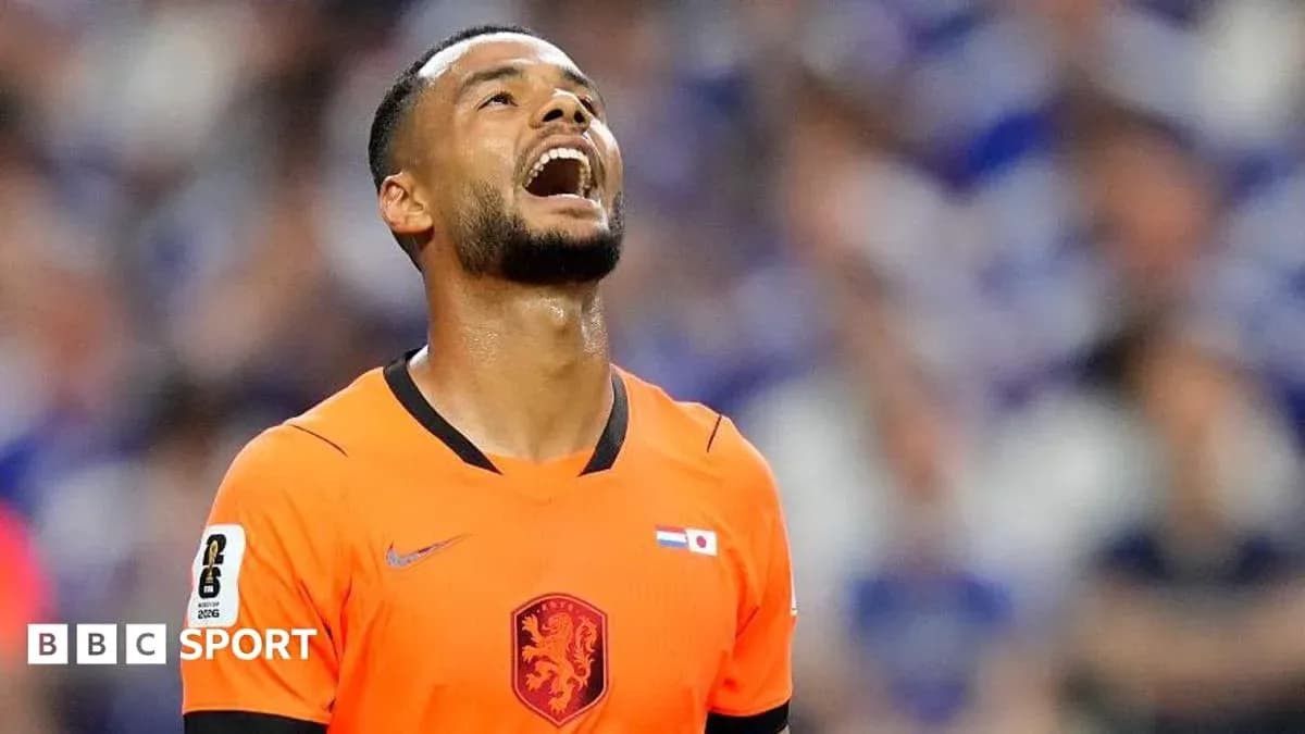 Player in orange jersey looking upwards during match