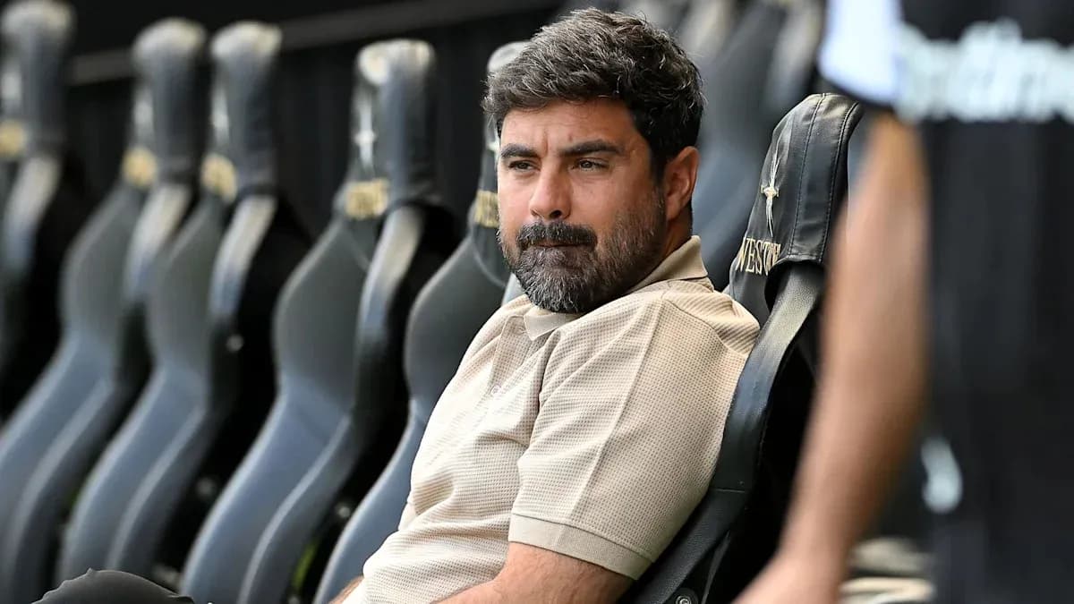 Coach seated on bench during a match