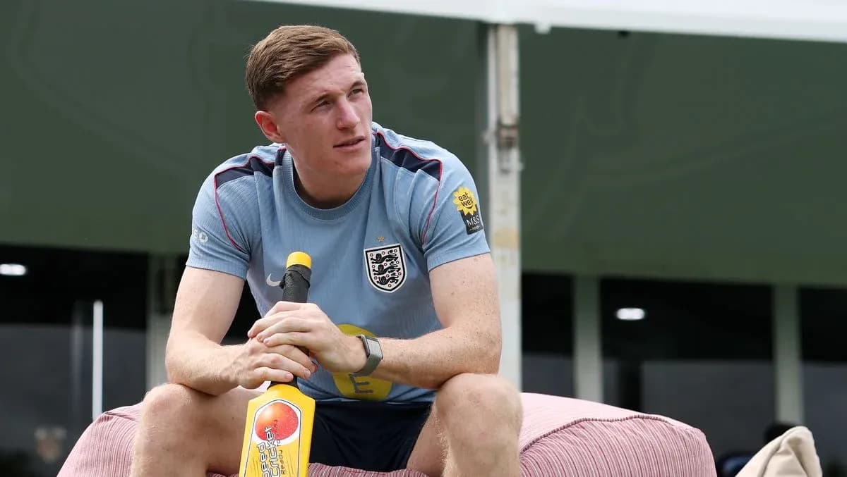 Player sitting with a cricket bat at training camp