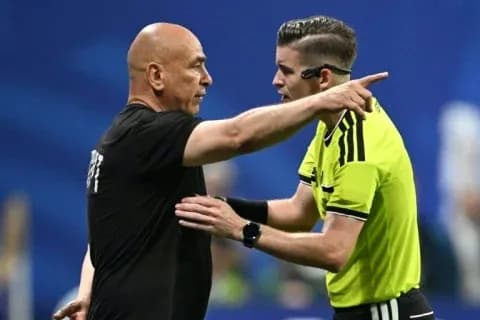 Referee discussing decision with team coach on field