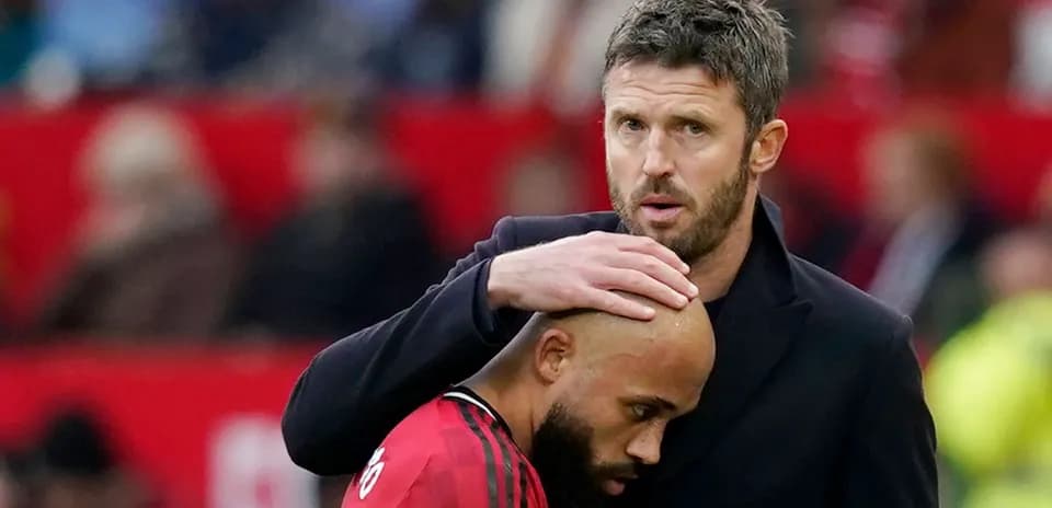 Coach comforting player on the sidelines