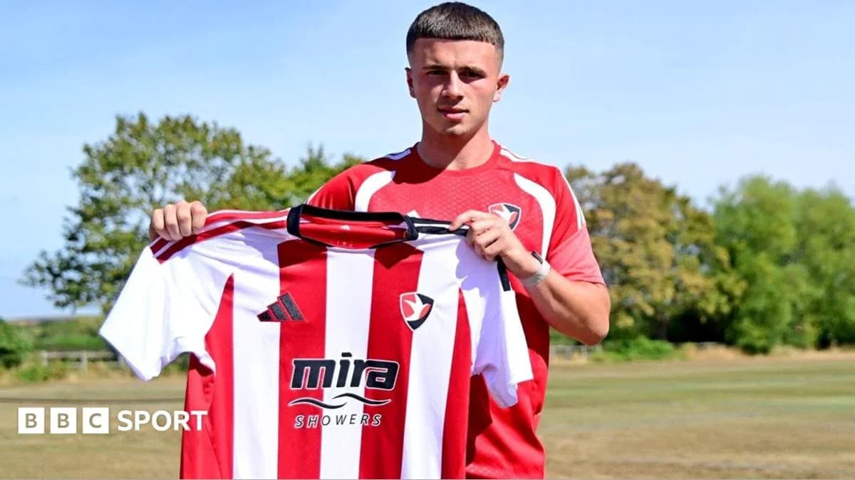 Player holding Cheltenham Town shirt during announcement