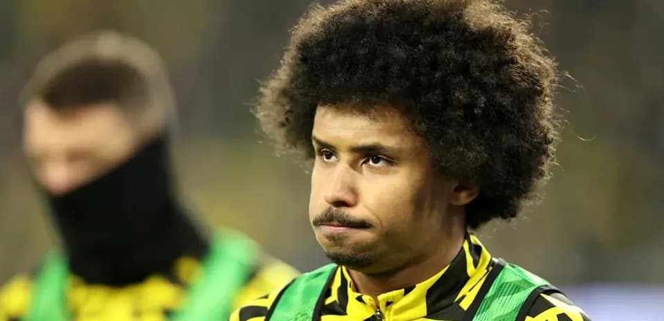 Player in team colors on the sidelines during match