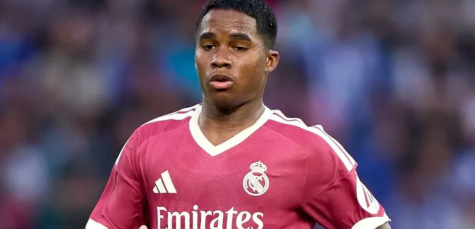 Player in pink Real Madrid jersey running on field