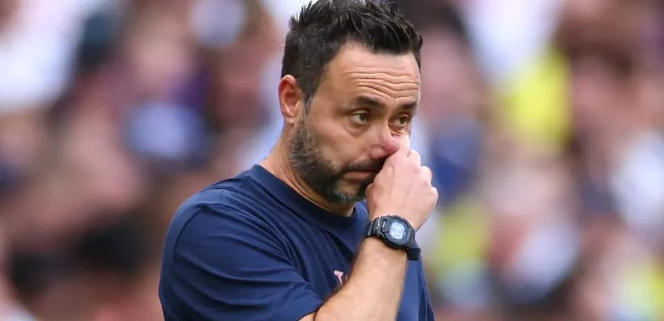 Coach observing the match with focused expression