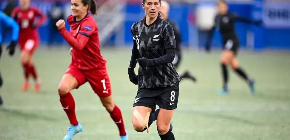 New Zealand player running during match against opponent