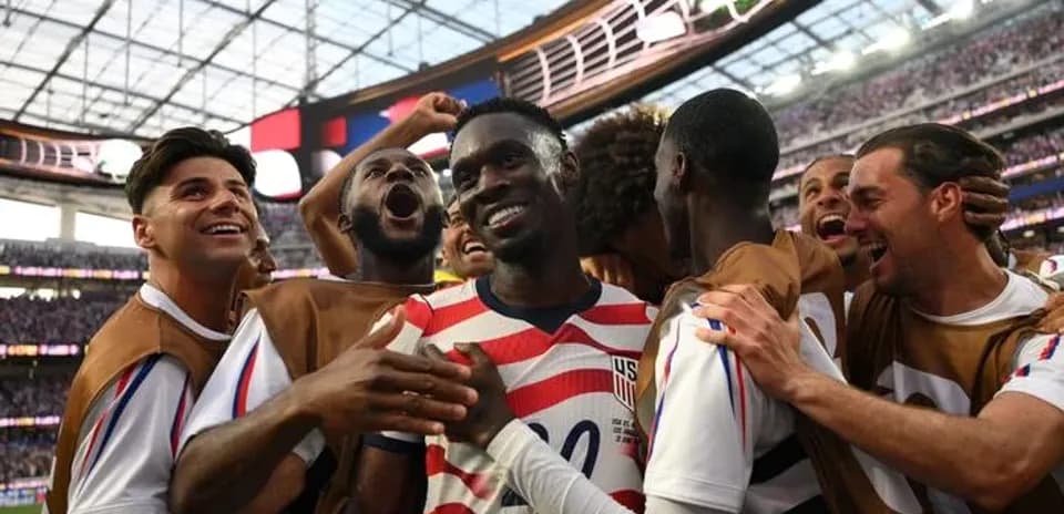US players celebrating together after scoring a goal