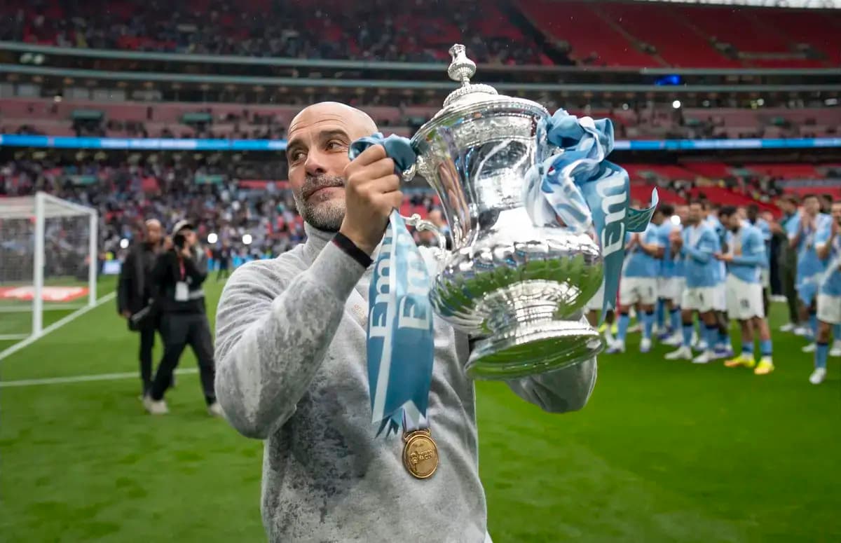 Coach holding FA Cup trophy at Wembley Stadium
