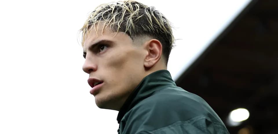 Player with slicked hair wearing a green jacket