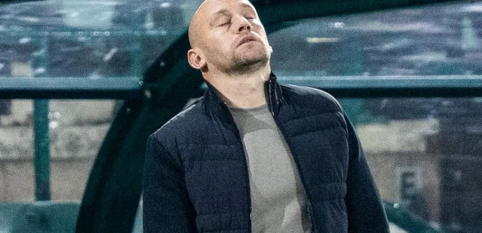 Coach looking up from technical area during match