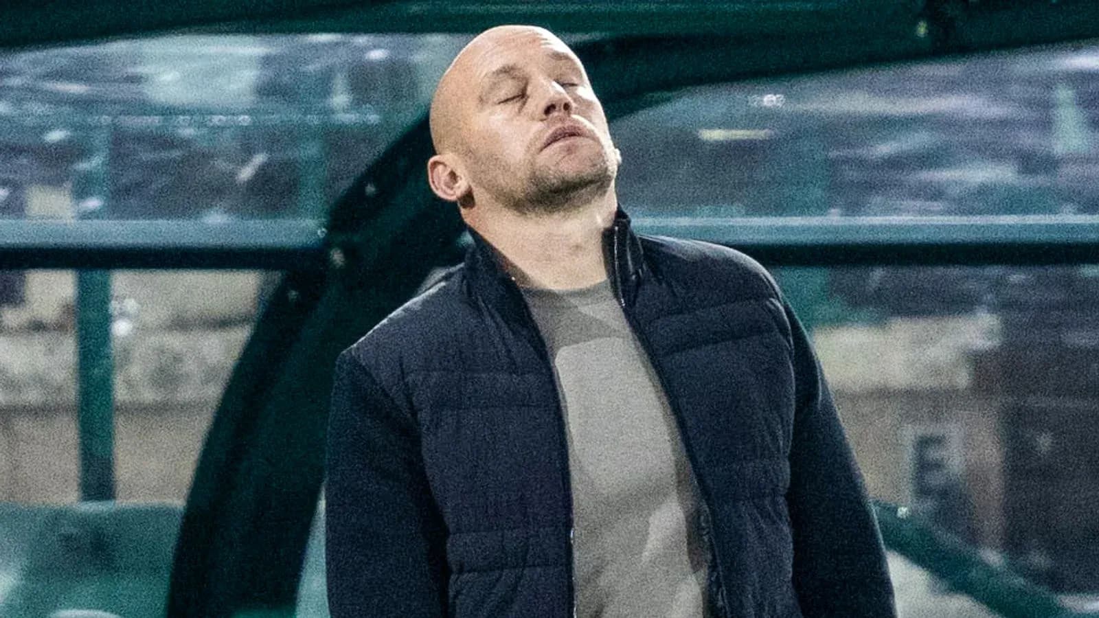Coach looking up from technical area during match