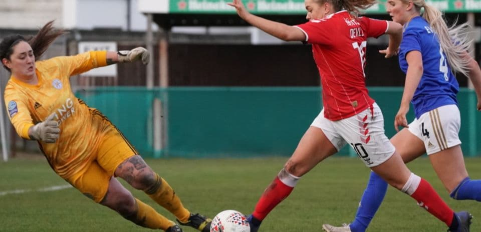 Player evading goalkeeper during match action