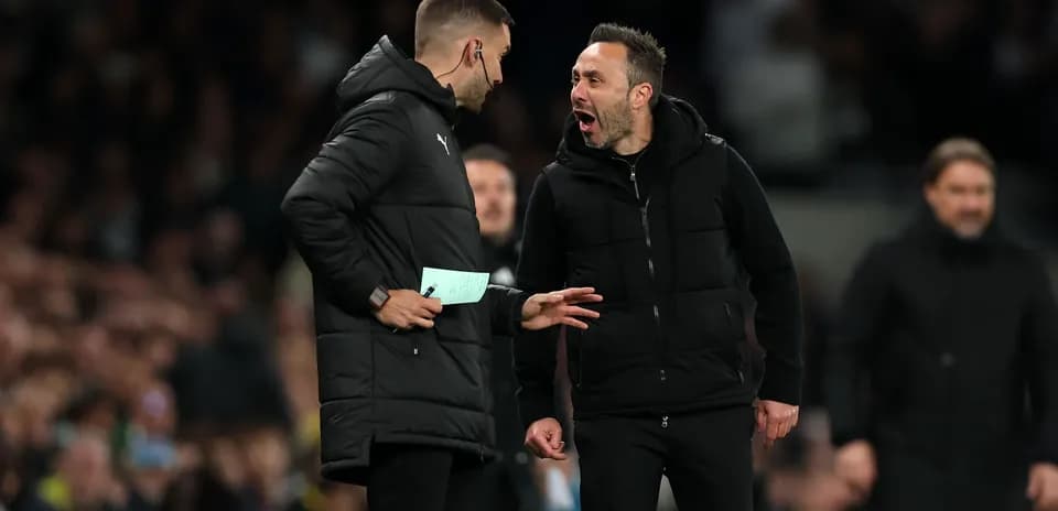 Two coaches discussing strategy during a match