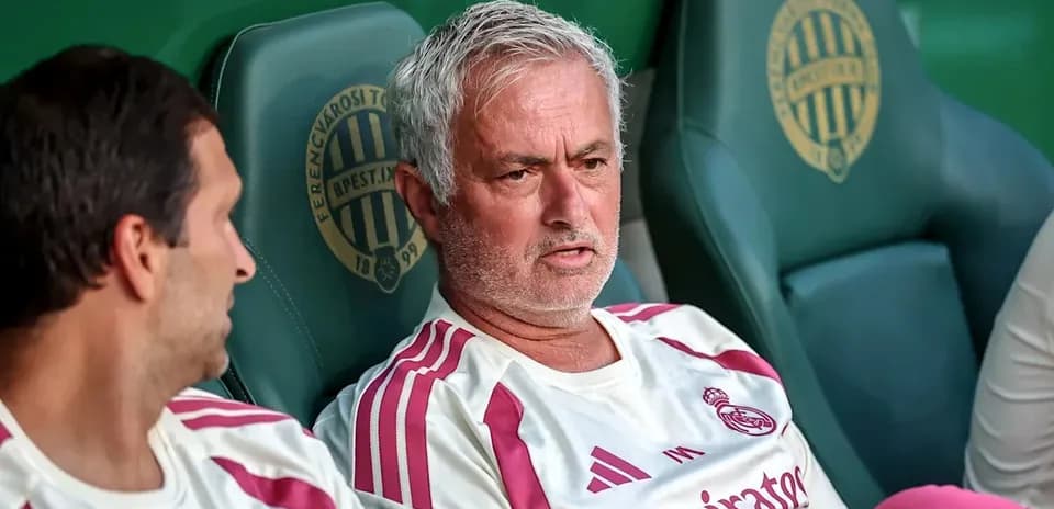 Coaches seated on the bench during match