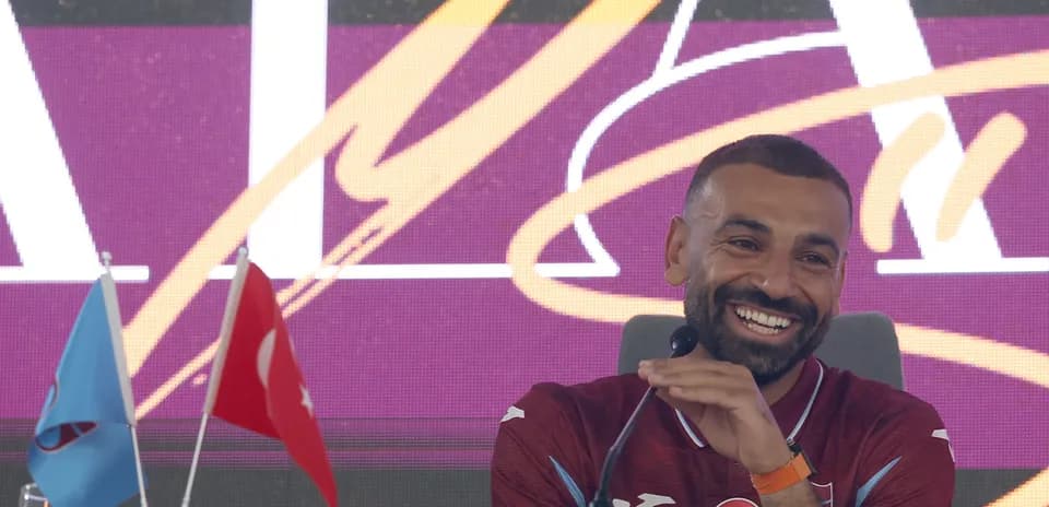 Player at press conference with Turkish flags
