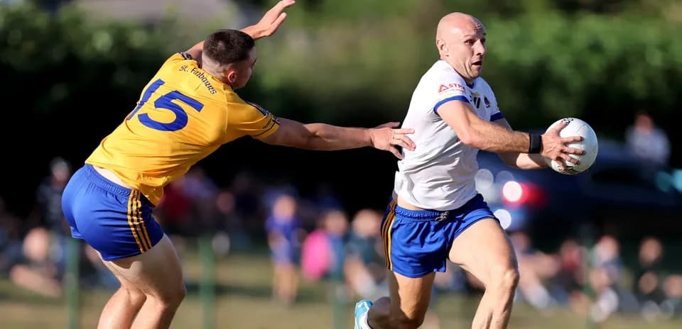 Player running with the ball while being tackled