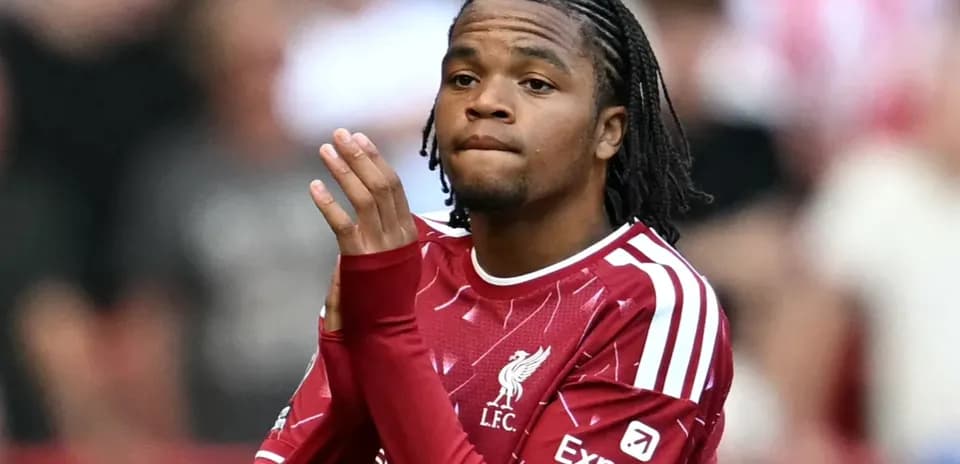 Player applauding fans while wearing Liverpool jersey