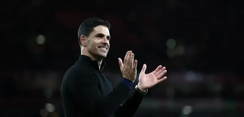 Manager applauding during match at stadium