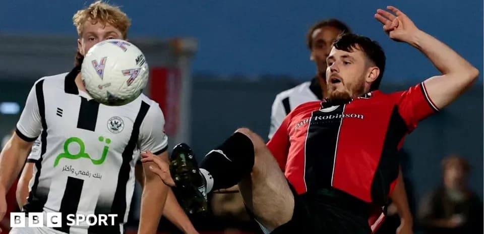 Player kicking ball while falling during match