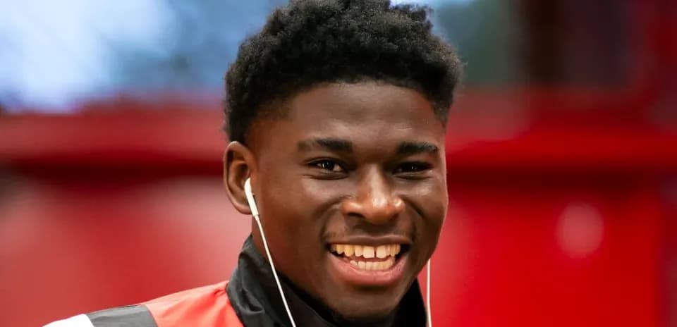 Young athlete smiling with earphones on