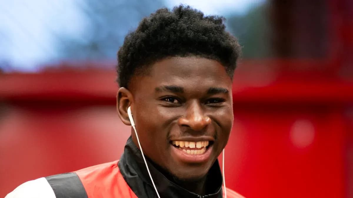 Young athlete smiling with earphones on