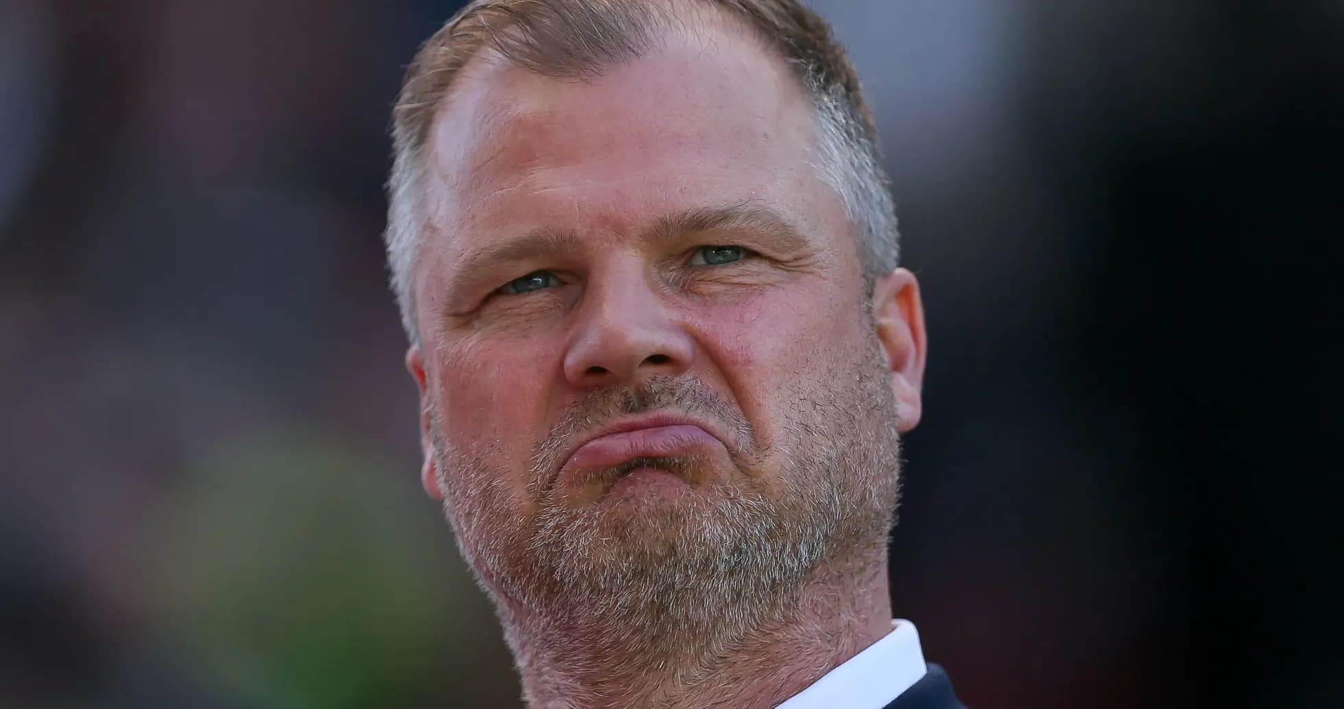 Man with serious expression during match observation