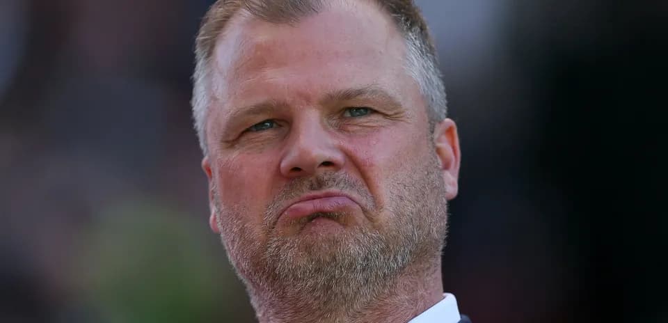 Man with serious expression during match observation