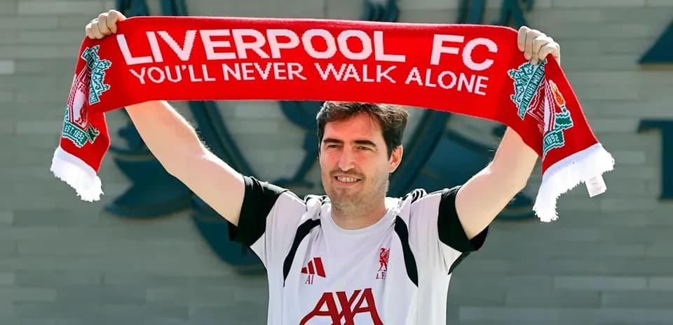 Man holding Liverpool FC scarf outside club
