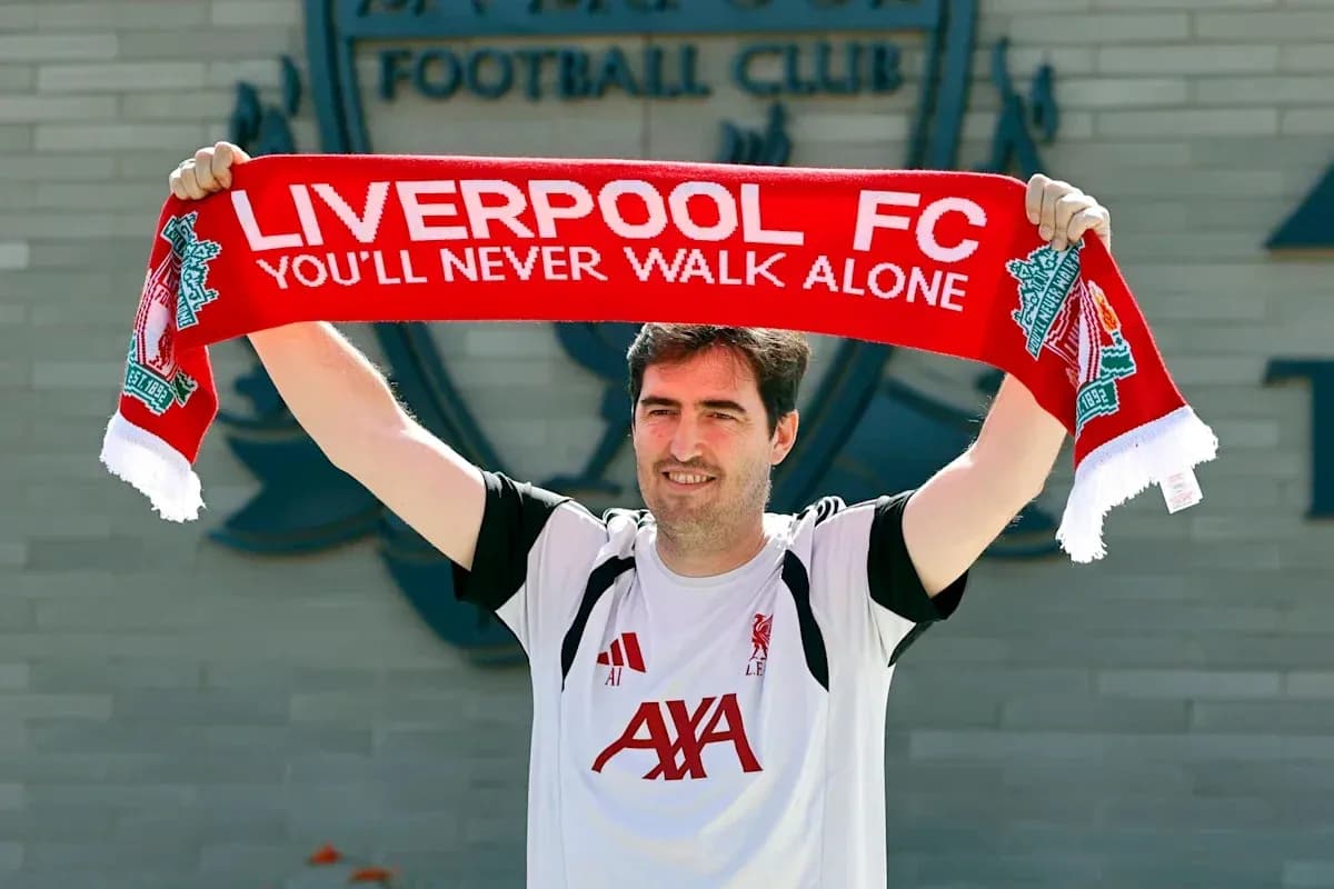 Man holding Liverpool FC scarf outside club