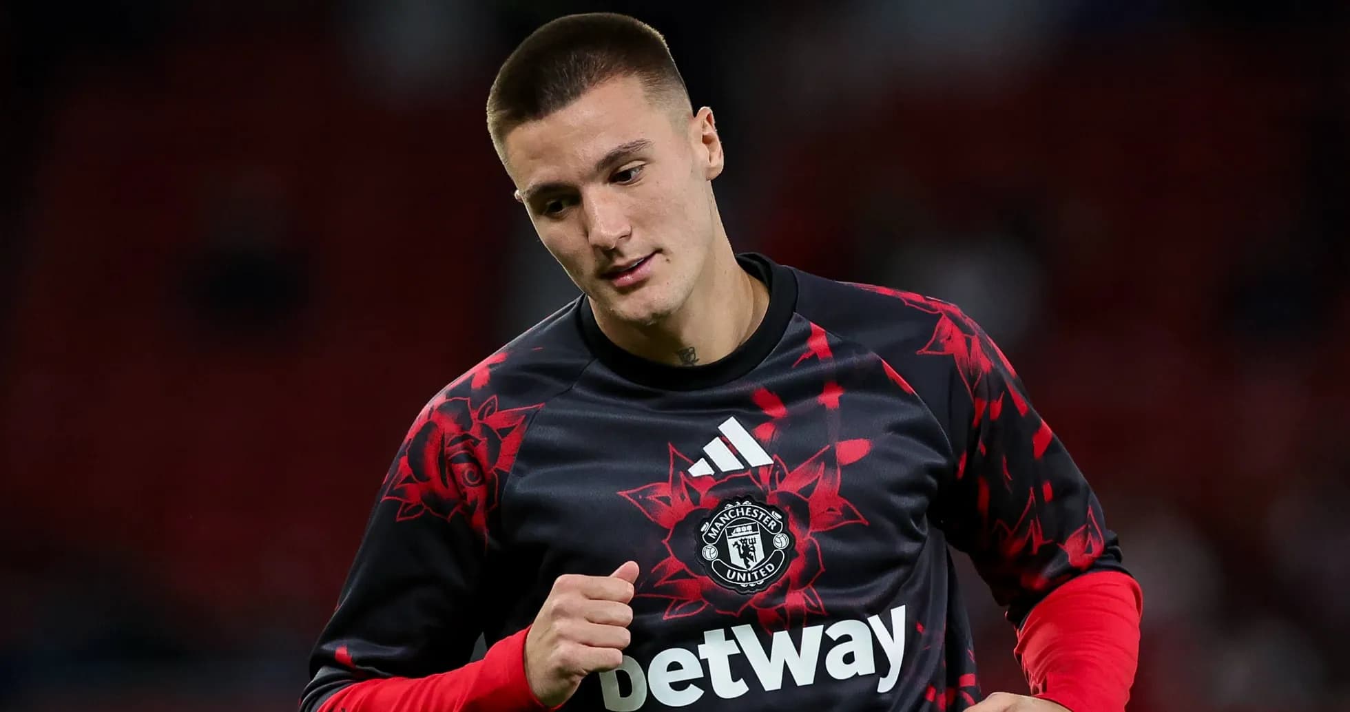 Player warming up in Manchester United training kit