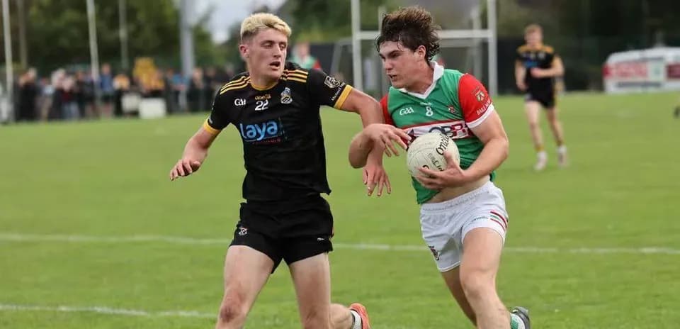 Two players competing for a Gaelic football