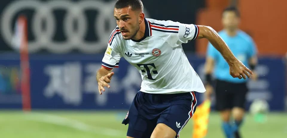 Player sprinting during a match in Bayern Munich kit