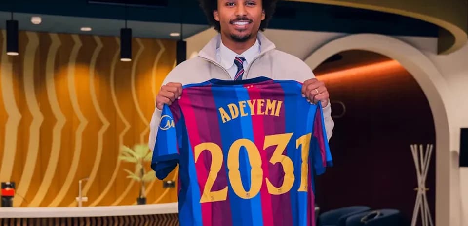 Player holding Barcelona jersey with 'Adeyemi 2031'