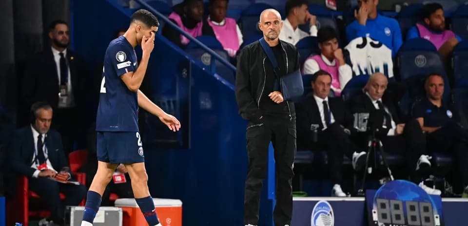 Player leaving pitch while coach observes during match