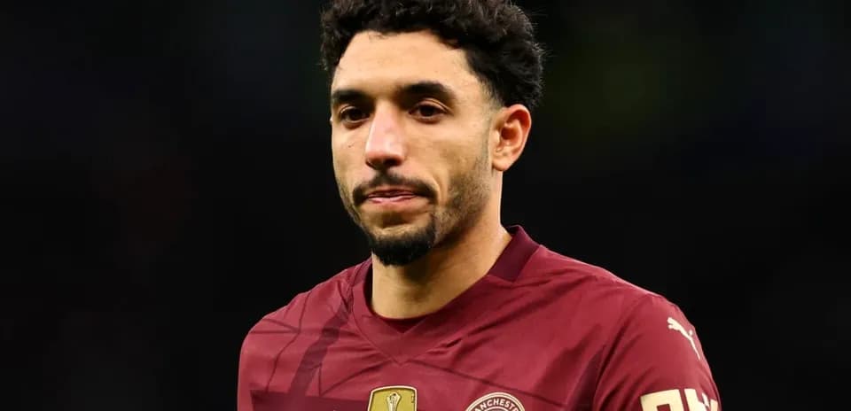 Player wearing Manchester City jersey on the field
