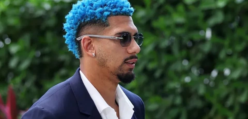 Man with blue hair wearing sunglasses outdoors