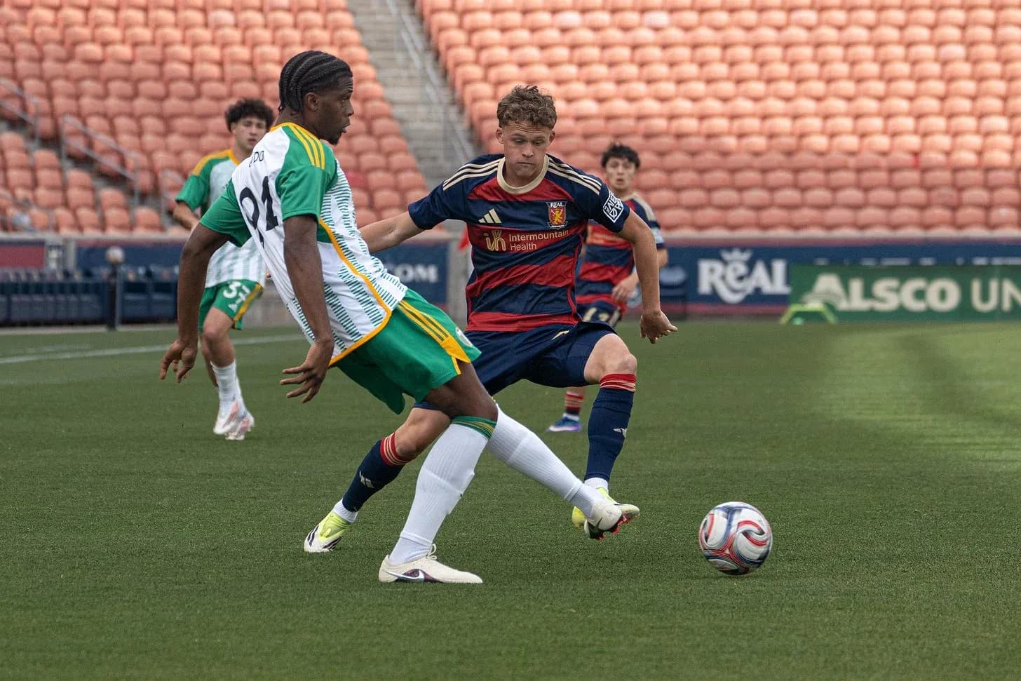 Players competing for the ball during match