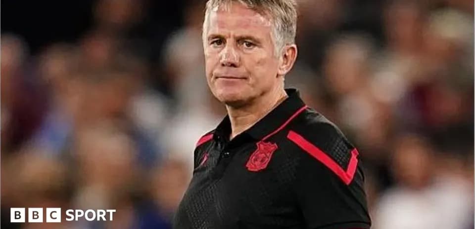 Coach standing on the sidelines during a match