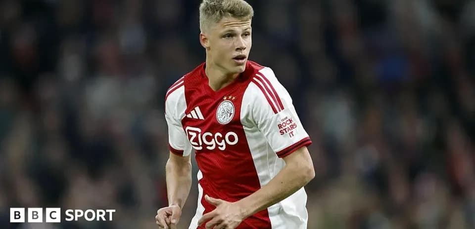 Player in Ajax jersey running during match