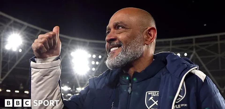 Manager celebrating with a thumbs up at stadium