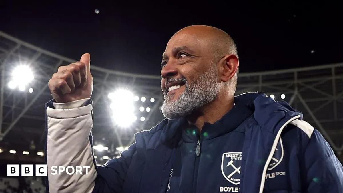 Manager celebrating with a thumbs up at stadium